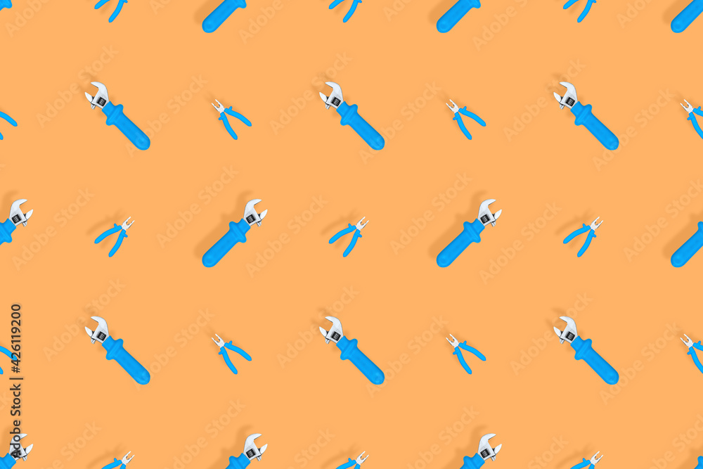 Tools seamless pattern. Background made of tools, pliers and an adjustable wrench. Tools seamless pattern. Background made of tools, pliers and an adjustable wrench.