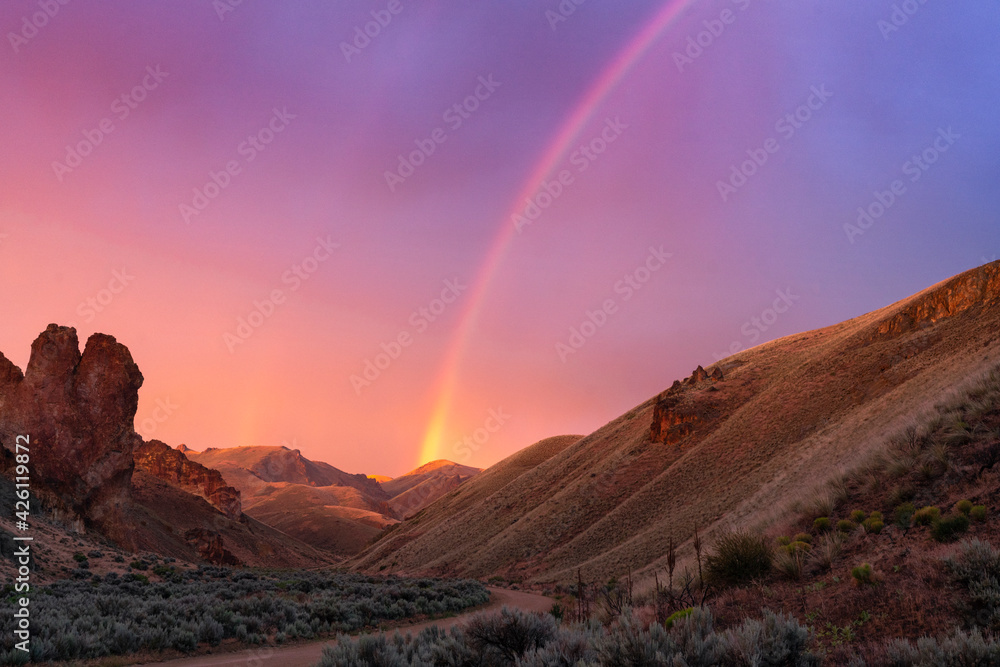 United States, Oregon, Rainbow above desert landscape at sunset