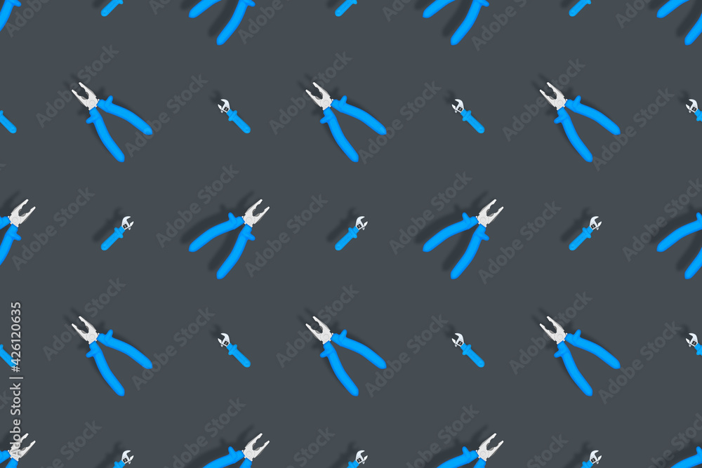 Tools seamless pattern. Background made of tools, pliers and an adjustable wrench. Tools seamless pattern. Background made of tools, pliers and an adjustable wrench.
