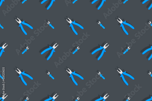 Tools seamless pattern. Background made of tools, pliers and an adjustable wrench.