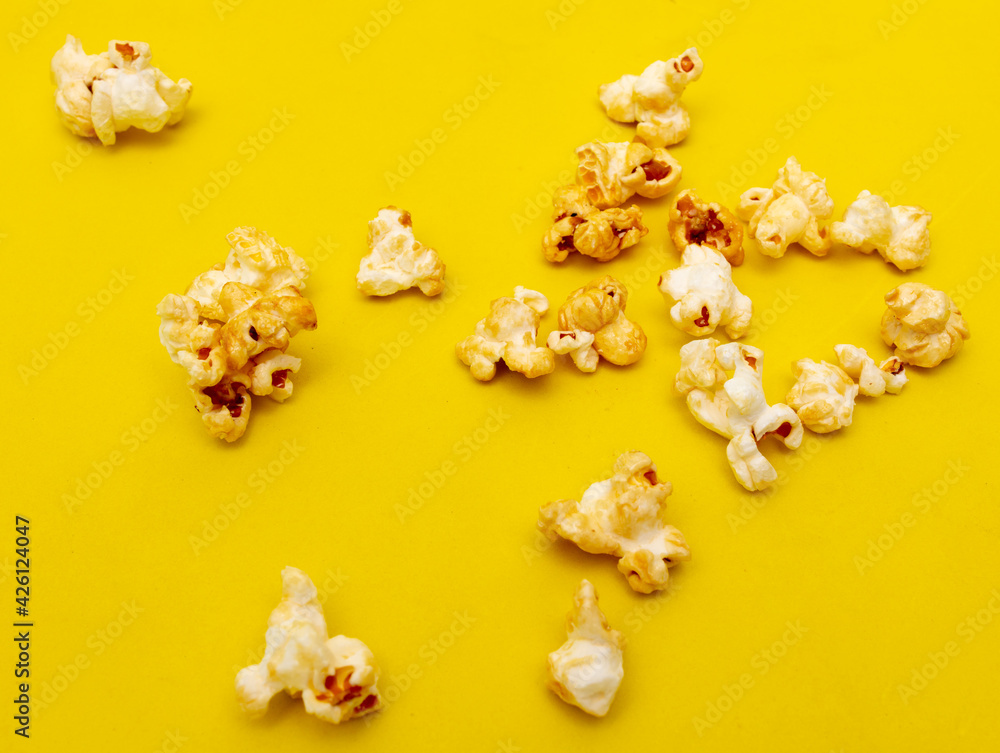 Close-up of popcorn on a yellow background. Close-up of popcorn on a yellow background.