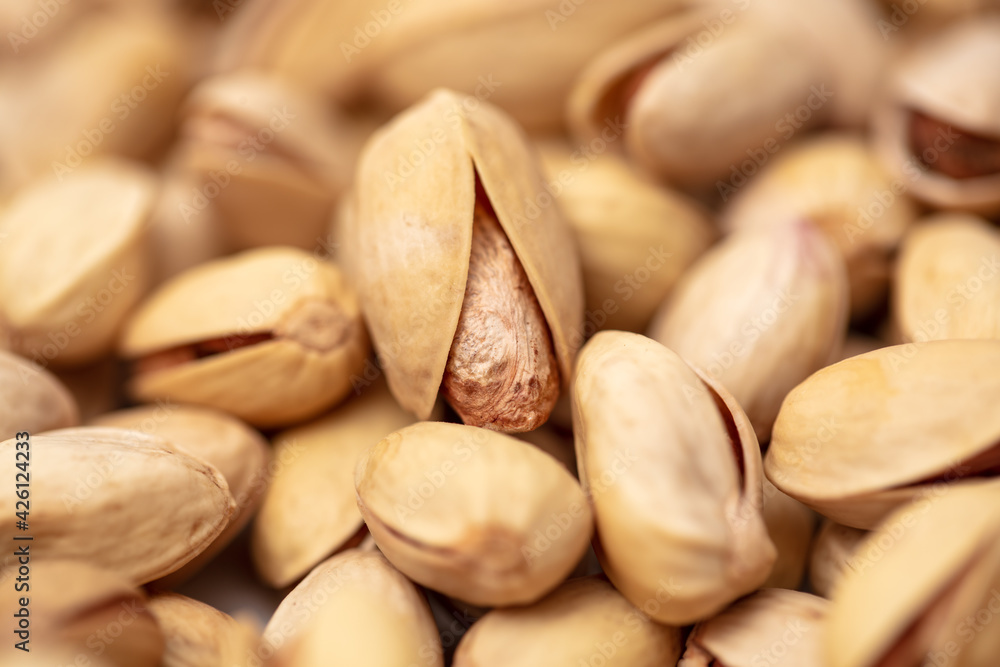Close-up of fresh pistachio nuts as background.