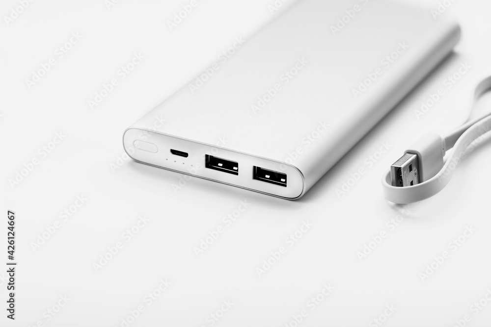 Powerbank for charging mobile devices with cable, on a white background. Powerbank for charging mobile devices with cable, on a white background.