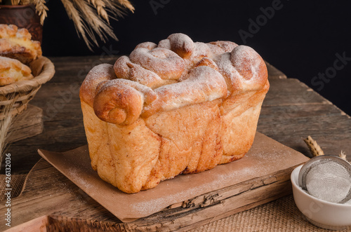 Beautiful loaf of white bread on wooden background photo