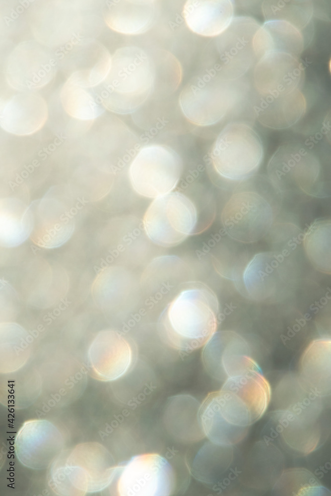 bright glitter background: bokeh effect from many colored lights on frozen glass, toning bright glitter background: bokeh effect from many colored lights on frozen glass, toning
