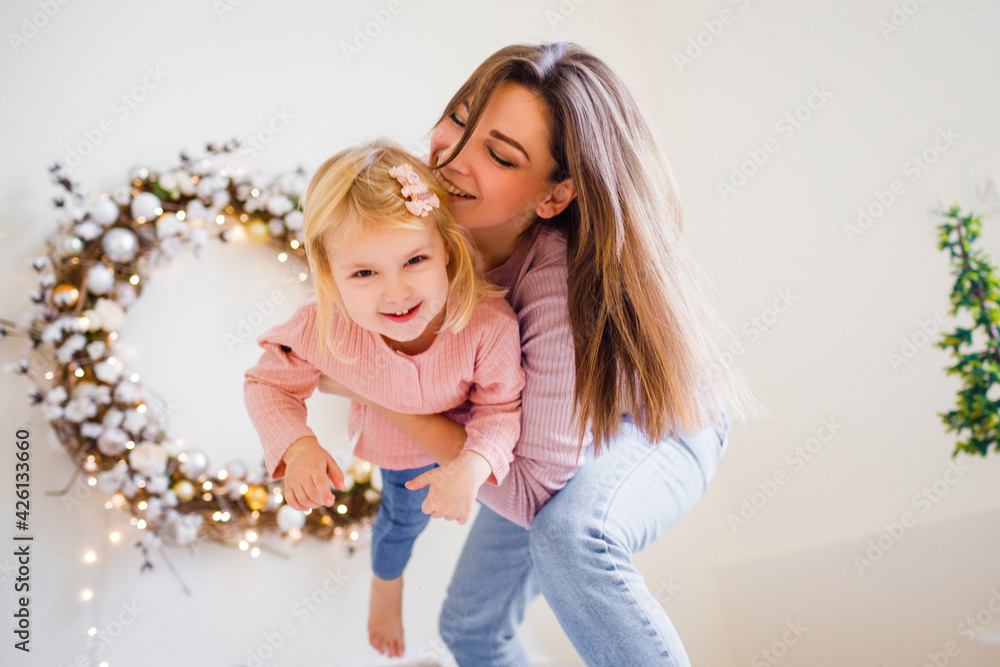 Mother plays with her daughter on the bed. Mother plays with her daughter on the bed.
