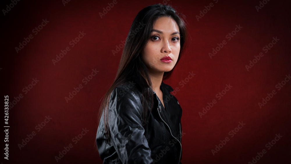 Sexy Asian woman poses in the studio for the camera - studio photography