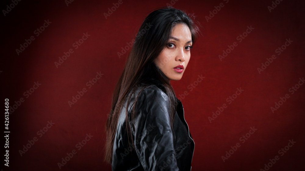 Naklejka premium Sexy Asian woman poses in the studio for the camera - studio photography