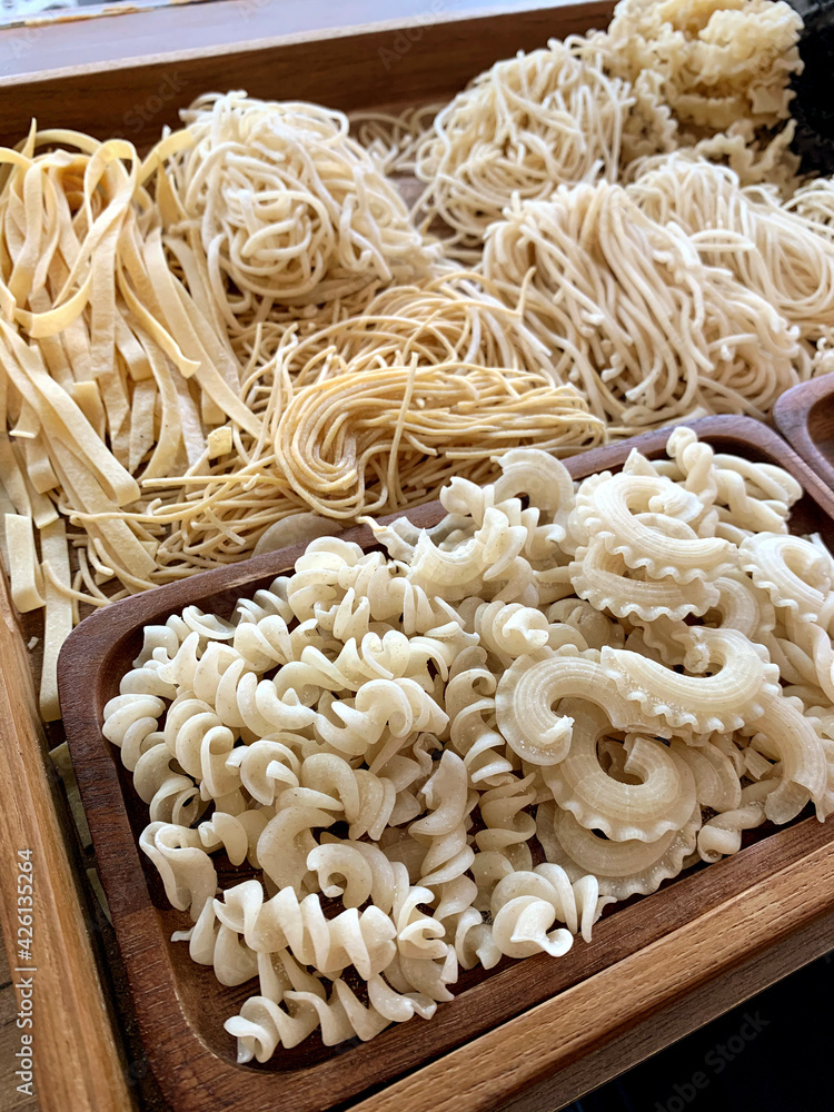 Different shapes and types of pasta noodles, example  rigatoni, fusilli, create di gale rigate, spaghetti, linguine, fettuccine, tagliolini, bucatini. Italian cuisine food, effect flare light