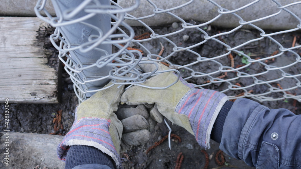 the process of pulling a galvanized metal mesh with hands in textile ...