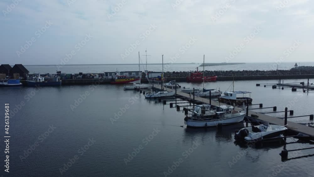 Drones flight in port with a couple of small fishermen and sail boats Drones flight in port with a couple of small fishermen and sail boats