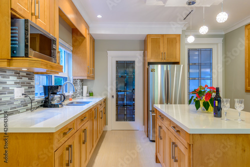 Modern  bright  clean  kitchen interior with stainless steel appliances in a luxury house