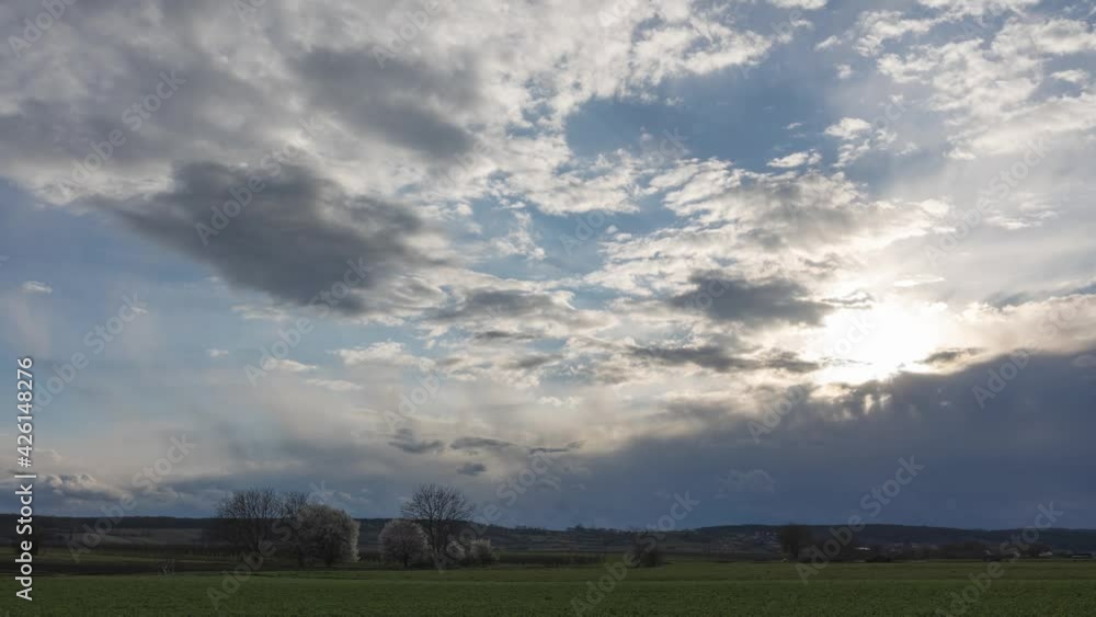 Time-lapse of fast clouds with light sun rays and rain clouds with sunset Time-lapse of fast clouds with light sun rays and rain clouds with sunset