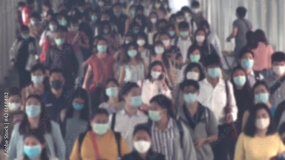 4K, Blurred defocused view of Concept of coronavirus quarantine, MERS-Cov. Large crowd of business people with medical face mask. Air pollution. 4K, Blurred defocused view of Concept of coronavirus quarantine, MERS-Cov. Large crowd of business people with medical face mask. Air pollution.