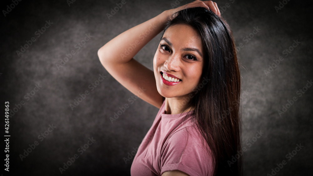 Happy young woman looks into the camera - studio photography Happy young woman looks into the camera - studio photography