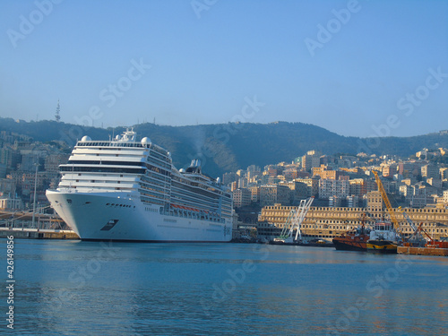 Genoa, Italy- April 01, 2021: Panoramic view of the waterfront and the old italian sea port in Genova by spring with blue sky and clear water. © yohananegusse