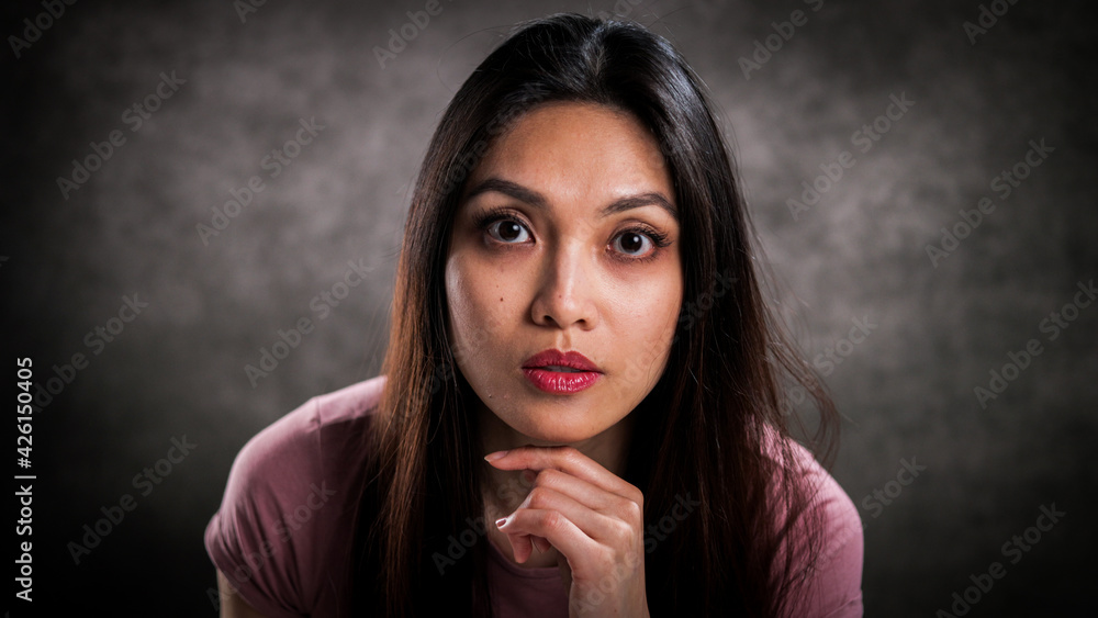 Pretty young woman in the studio against a grey background - studio photography Pretty young woman in the studio against a grey background - studio photography