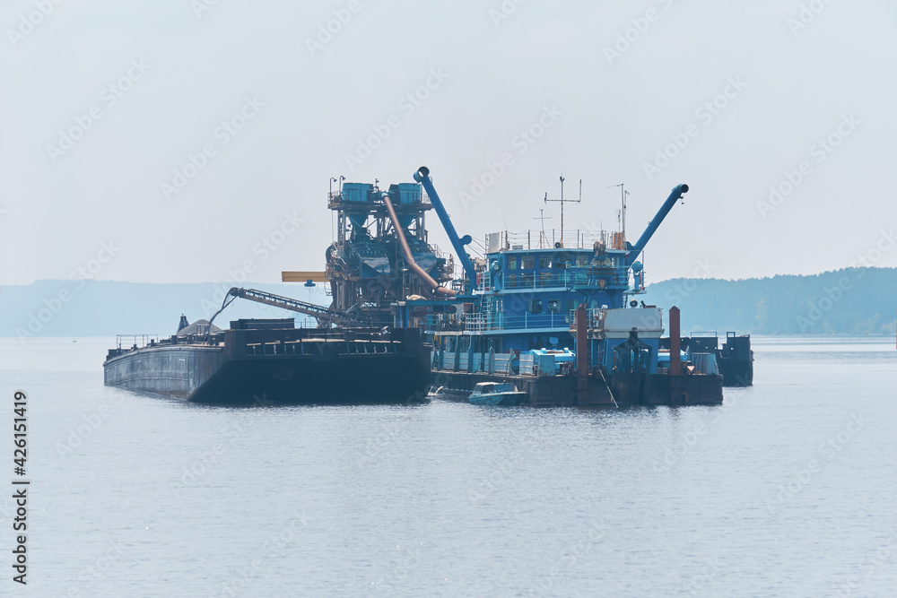 floating sand mining plant - dredger and separator - on the river
