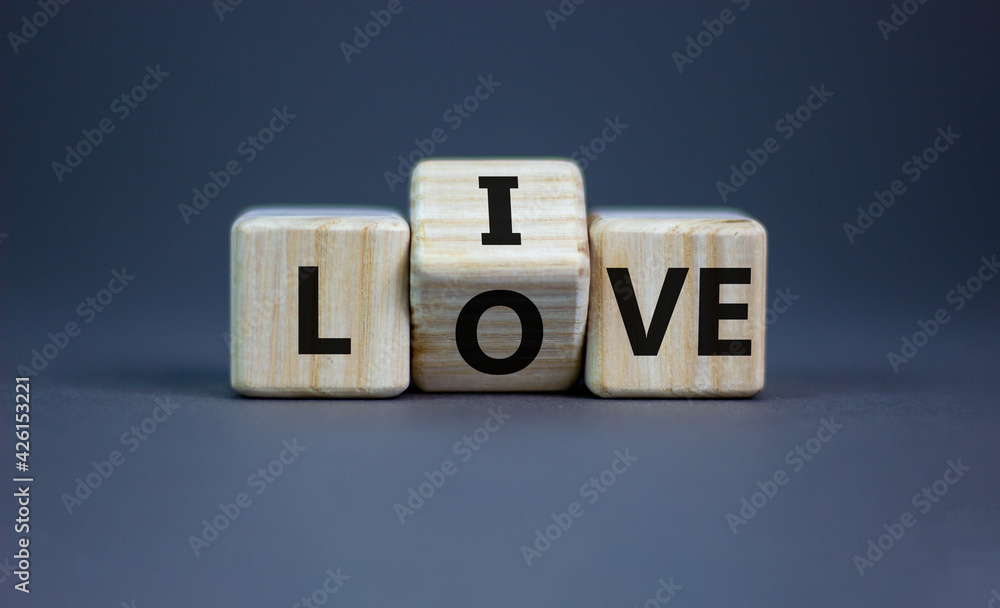 Live your love symbol. Turned cubes and changed the word 'live' to 'love'. Beautiful grey background, copy space. Business, live your love concept. Live your love symbol. Turned cubes and changed the word 'live' to 'love'. Beautiful grey background, copy space. Business, live your love concept.