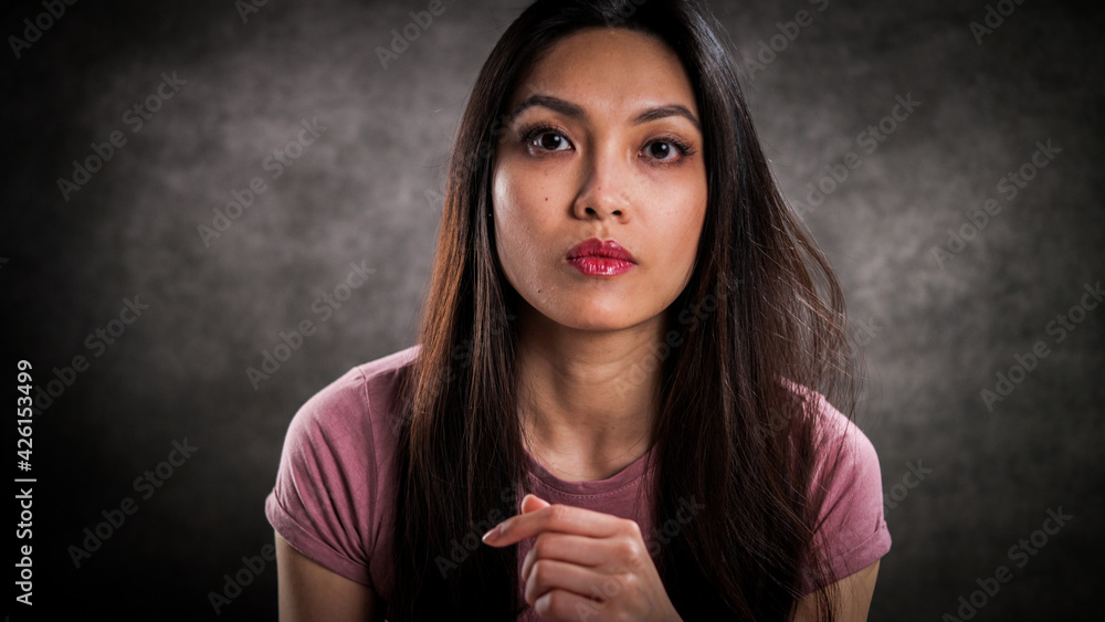 Pretty young woman in the studio against a grey background - studio photography Pretty young woman in the studio against a grey background - studio photography