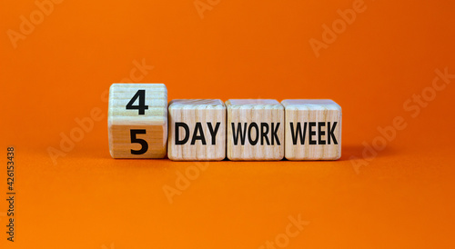 4 or 5 day work week symbol. Turned the cube and changed words '5 day work week' to '4 day work week'. Beautiful orange background. Copy space. Business and 4 or 5 day work week concept. photo