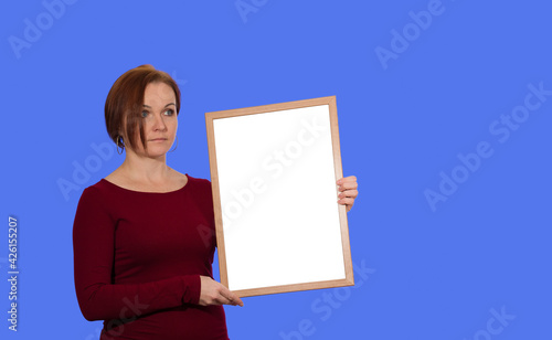 The woman in the red dress holds the board to the left. On a blue isolated background.