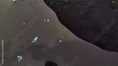 A glacier lake that is black because of the cryconite. Some of the white and blue ice parts show a nice contrast. Snæfellsjökull galcier in Iceland. photo