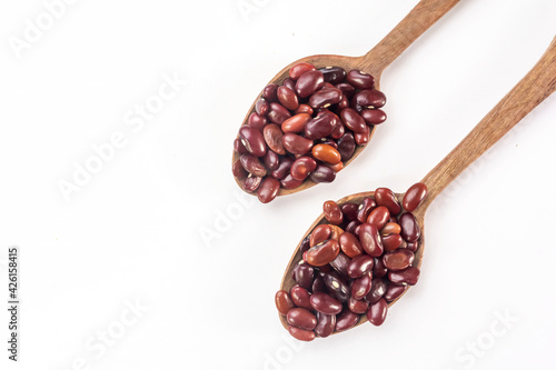 Fresh organic red kidney beans or rajma in a wooden spoon on white isolated background. photo