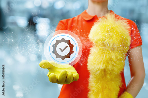 Φωτογραφία Cleaning lady shows a icon of well-done work on a blurred background