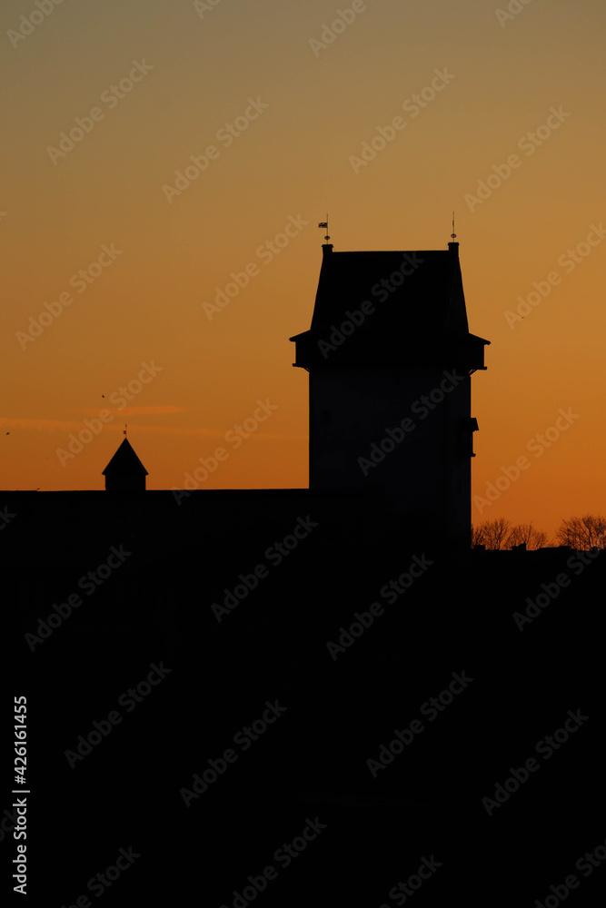 silhouette of a Narva castle on the orange beautiful sunset