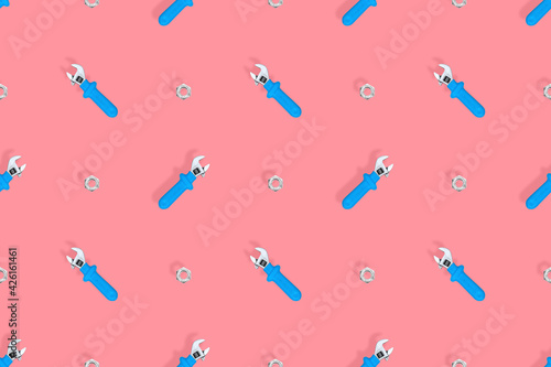 Wrench with nut seamless pattern. Background on the theme of repair or construction. 