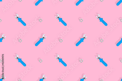 Wrench with nut seamless pattern. Background on the theme of repair or construction. 