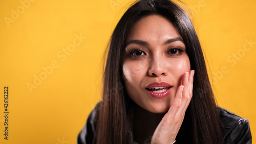 Young woman with a pretty face poses for the camera - studio photography © 4kclips