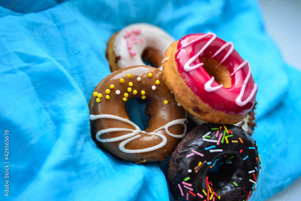 Delicious colorful donuts with different flavors on the background