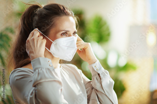 Photographie trendy woman in grey blouse wearing ffp2 mask