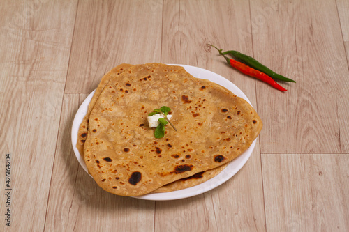 Popular breakfast dish Parotta or Paratha is a layered flatbread made from maida flour, served in ceramic plate or platter in India.