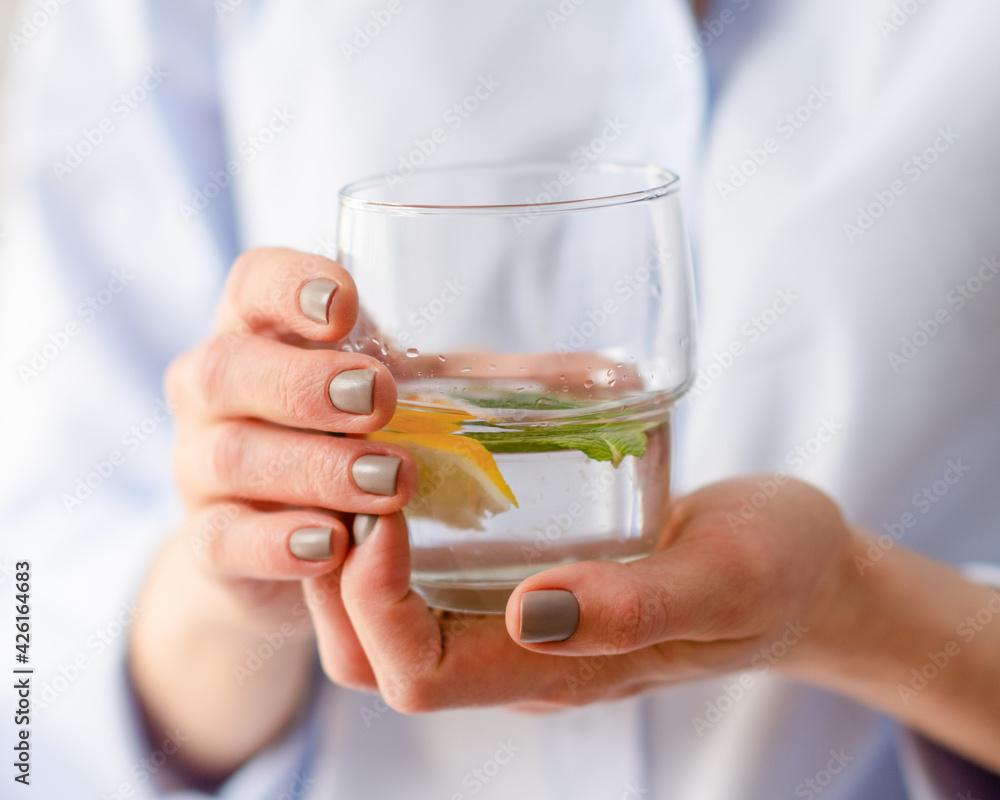 woman holding a glass of fresh water woman holding a glass of fresh water