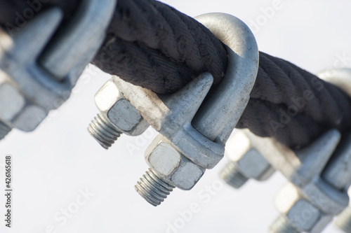 The U-Bolts are close up. The fastening of steel wire ropes with safety locking U-Bolts. photo