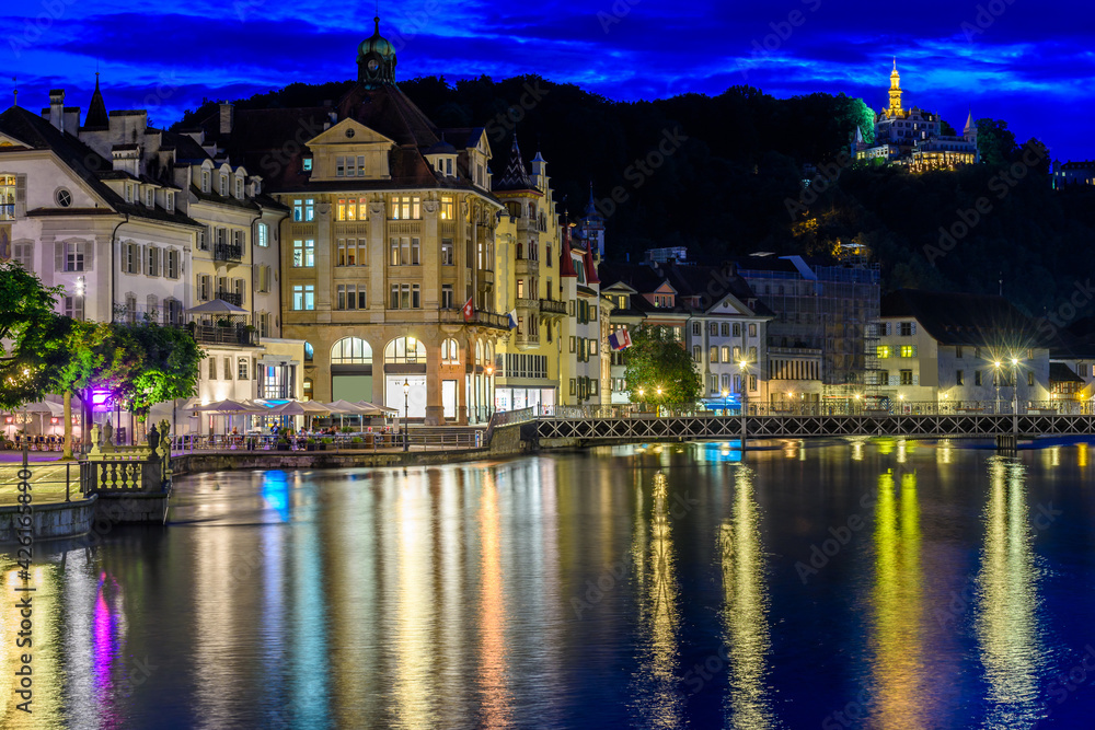 Night view towards Chapel Bridge (Kapellbruecke) together with the octagonal tall tower (Wasserturm) it is one of the Lucerne's most famous tourists attraction