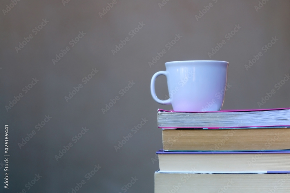 Stack of books and cup of tea or coffee. Selective focus. Stack of books and cup of tea or coffee. Selective focus.