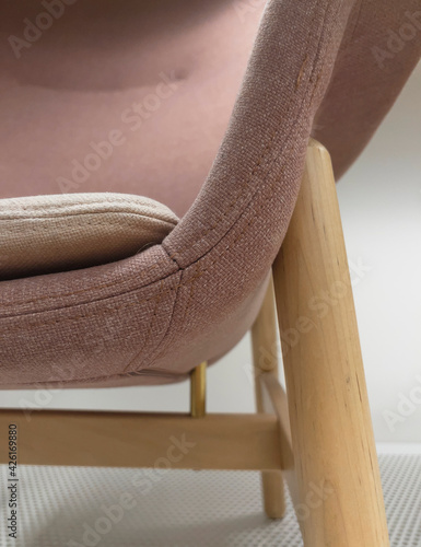 Detail of a wooden chair with a pink cover in the furniture center