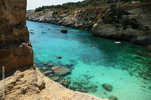 Santa Cesarea Terme, Puglia, Italy - july 14, 2017: Bay of Porto Miggiano. The amazing view of the deep blue and cerulean sea and mediterranean beach. Rocky landscape. Salento Adriatic sea coast