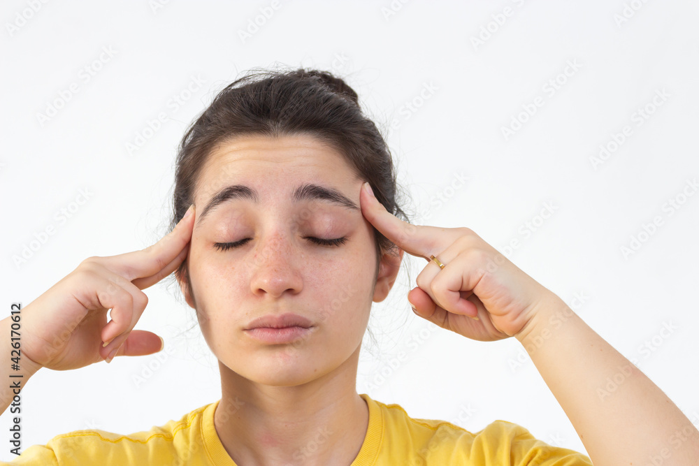 Woman with yellow t-shirt on white background in pain from relaxing Woman with yellow t-shirt on white background in pain from relaxing