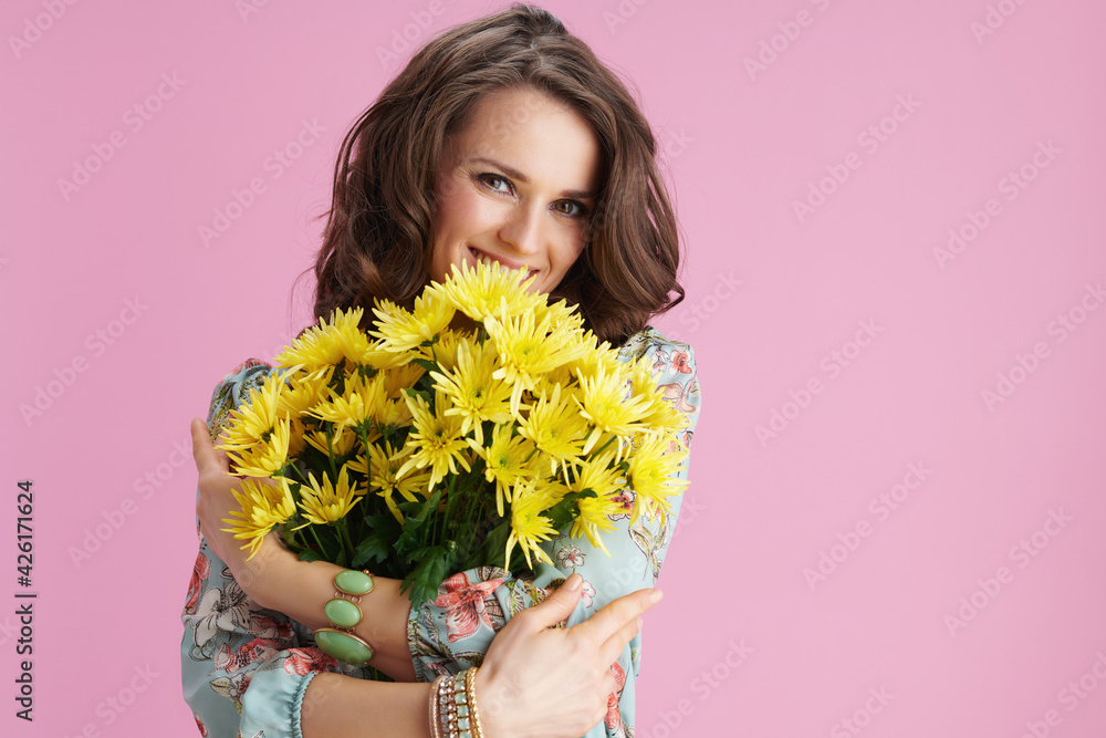 happy modern woman in floral dress on pink happy modern woman in floral dress on pink