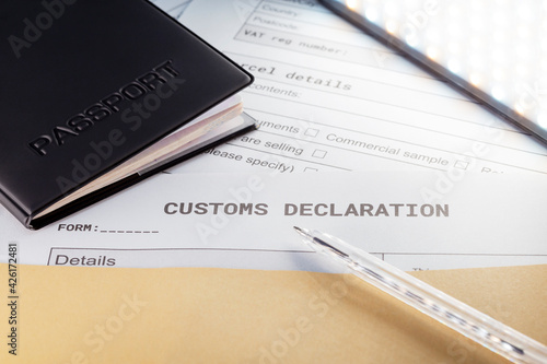 Bild auf Leinwand a Passport over Customs Declaration form