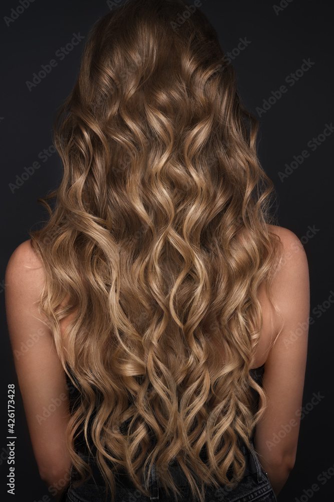 Fototapeta premium A closeup view of a bunch of shiny curls blond hair