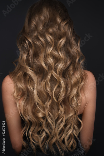 A closeup view of a bunch of shiny curls blond hair