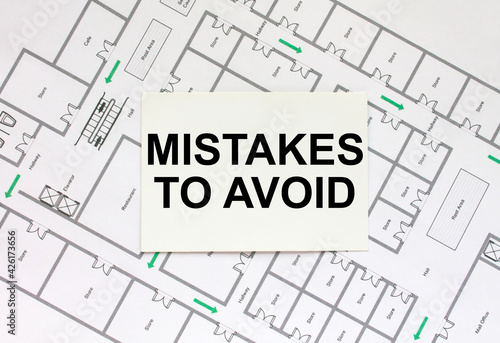 Business card with text Mistakes To Avoid on a construction drawing