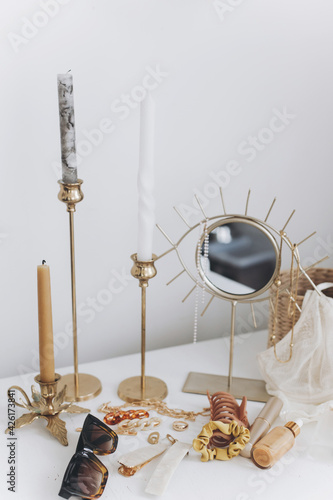 Summer accessories. Gold jewellery, sunglasses, cosmetics, perfume, lingerie, candles, boho mirror photo