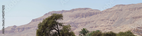 Landscape with mountains and trees in Egypt. Rocky hills. Blue sky